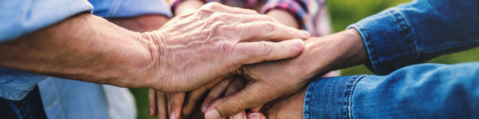 hands-of-small-girl-and-her-senior-grandparents-EKH9UTX.jpg